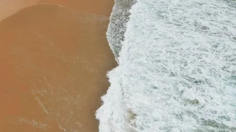 Close-up drone of waves crashing into tilt up Stock Footage 304267513