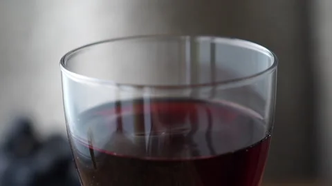 Close up of a drop falling into a wine glass Stock Footage 232400621
