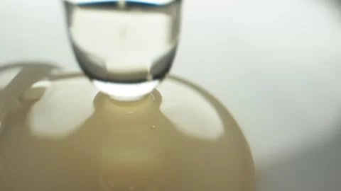 Close-up of a drop of liquid medicine falling from the tip of a pipette Stock Footage 292441412