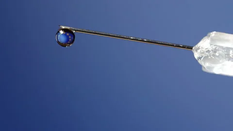 Close-up of a drop in a syringe with the European Union flag waving inside. Stock Footage 144431953