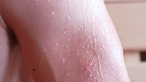 Close-up of a drop of water on the body after a shower. Drops of sweat on a man Stock Footage 223880032