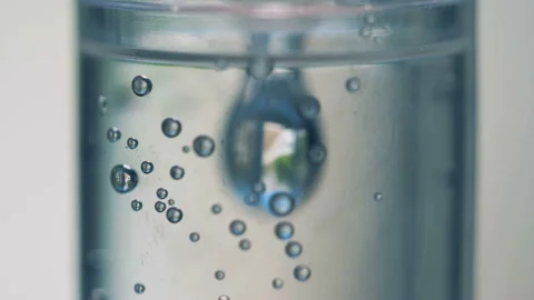 Close up of droplets falling and setting on the walls of a drop counter close up Stock Footage 93538313