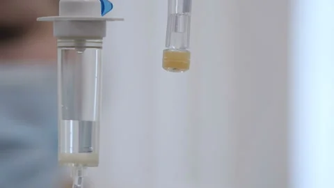 A close-up of a dropper and part of a nurse's face Stock Footage 92103598