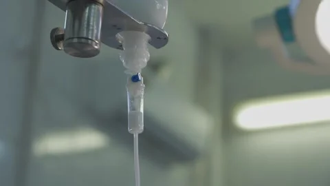 Close-up of a dropper with saline solution. Intravenous drip treatment. Video stock 250346642
