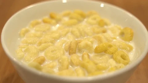 Close up dropping corn flakes to a bowl Stock Footage 109535982