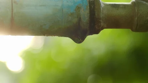 Close-up drops of leaking water from garden faucet Stock Footage 109320828