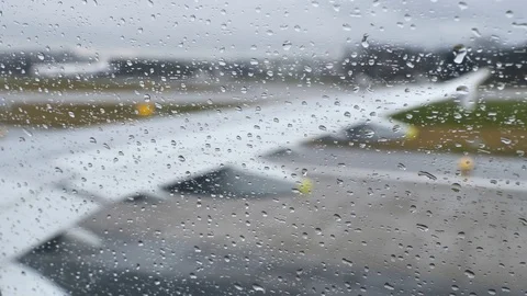Close up on drops of rain on a plane window during takeoff Stock Footage 122152303