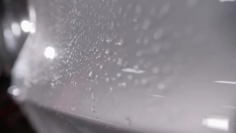 Close up. Drops of water on the gray glossy surface of the car body. Video stock 240733167