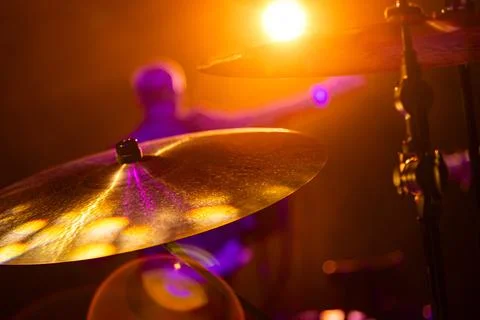 Close-up of drum kit cymbals on stage during a live music concert with a bl.. Stock Photos