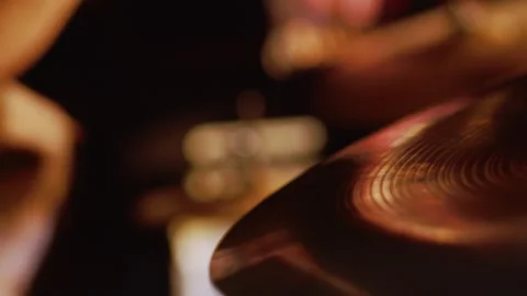 Close-up Drum set in a dark room illuminated by the golden light. Atmospheric Stock Footage 251775556