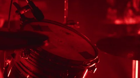 Close up of drum set under red light at live rock concert performance Stock Footage 341319233