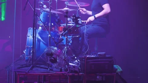 Close-up of a drummer behind a blue drum kit. A man rhythmically playing Stock Footage 253504299