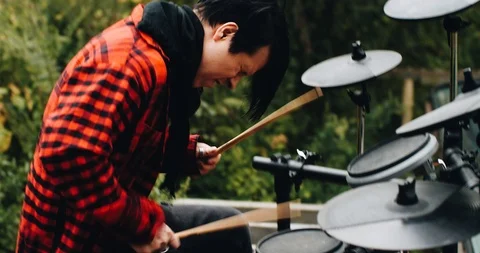 Close-up of the drummer behind the electronic drum kit 스톡 동영상 114519912