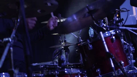 Close up of drummer man plays drums at the concert. Smoke in the background Stock Footage 80592778