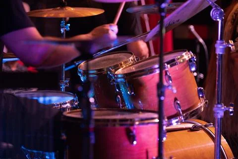 Close-up of a drummer playing a drum kit, capturing the motion and energy. Stock Photos
