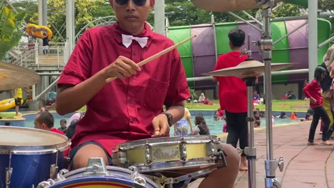 Close up of a drummer playing drum at local swimming pool Stock Footage 255696268