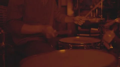 Close-up of a drummer playing a snare drum in red stage lighting. Stock-Footage 330239324