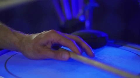 Close-up of a drummer's hand with a blue background Stock Footage 200227364