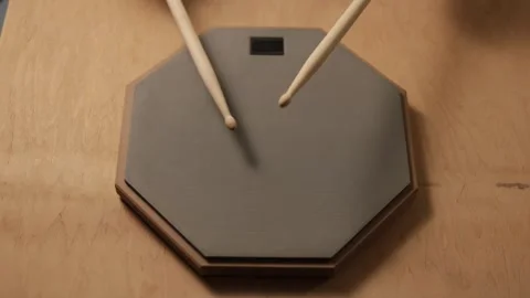 Close-up of drumsticks practicing on a silent practice pad Vidéo 341737775