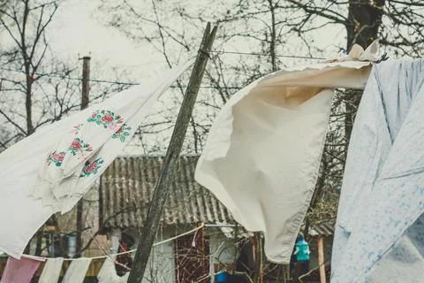 Close up dry clothes on laundry line waving in wind concept photo Stock Photos