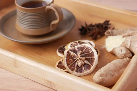 Close up of dry lemon, ginger and green tea on table Stock Photos