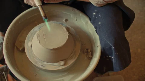 Close Up of Drying Base of Clay Bowl with Torch on Pottery Wheel Stock Footage 319232108