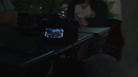Close-Up of DSLR Camera Screen on Outdoor Table at Night Stock-Footage 342562918