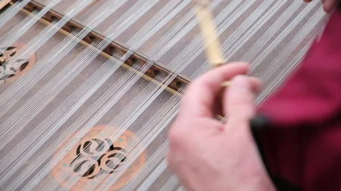 Close up of dulcimer string and wooden bat. Playing traditional musical instrume Video stock 163530094