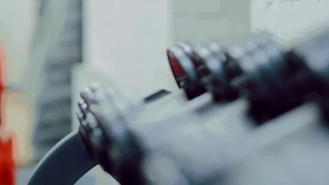 Close-Up of Dumbbell Lying on Rack in Gym Sports Equipment Concept for Effe.. Stock Footage 256750191