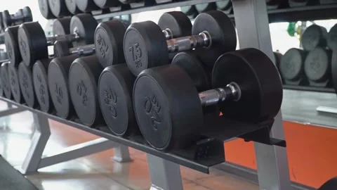 Close-Up of Dumbbell Lying on Rack in Gym Sports Equipment Concept for Effe.. Stock Footage 256750281