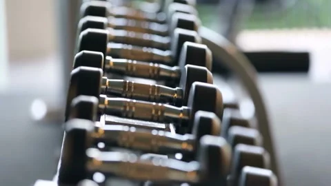 Close-Up of Dumbbell Lying on Rack in Gym Sports Equipment Concept for Effe.. Stock Footage 256750706