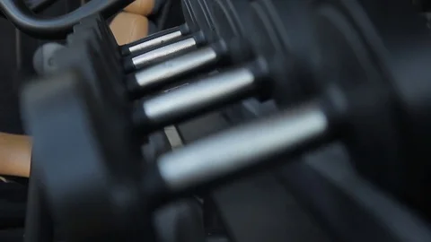 The close up of dumbbells lying on the rack in the modern gym. Stock Footage 84328698