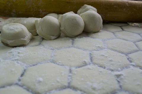 Close-up of dumplings on the background of a rolling pin. Handmade dumplings. Stock Photos