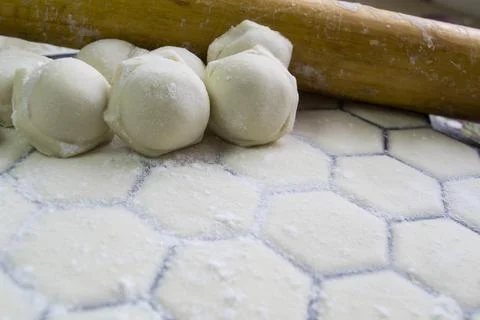 Close-up of dumplings on the background of a rolling pin. Handmade dumplings. Stock Photos