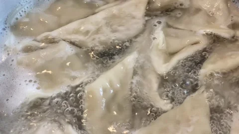 Close-up of dumplings in boiling water Stock Footage 277602057