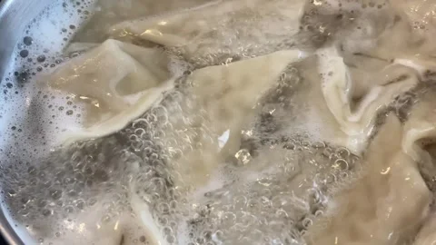 Close-up of dumplings in boiling water Stock Footage 277602085