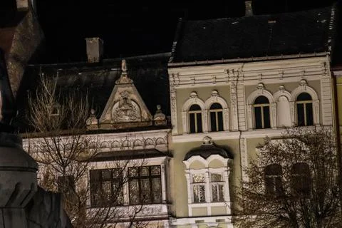 A close up during night time of two old gothic style buildings during 18th ce Stock Photos