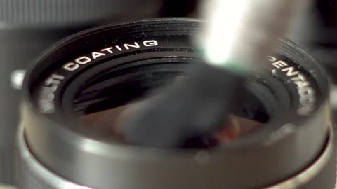 Close-up of dusting camera lens with brush Video stock 138207937