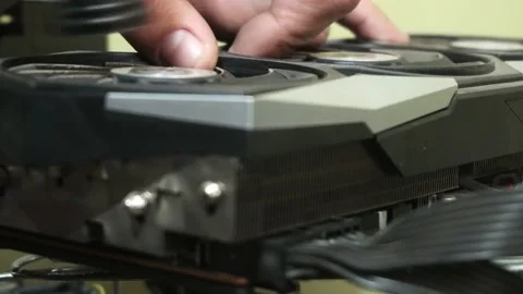 Close-up dusting off a cryptocurrency mining PC graphics card with an electric Stock Footage 167245961