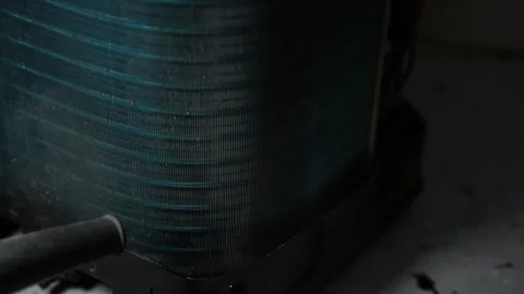 Close-up of a dusty air conditioner condenser coil in low light, Metal fins.. 動画素材 338319416