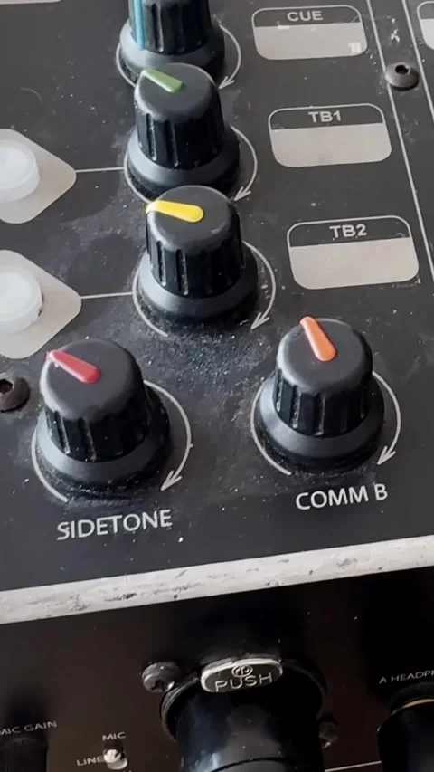 Close-up of a dusty audio intercom panel with colored knobs, sidetone and COMM Stock-Footage 337228881