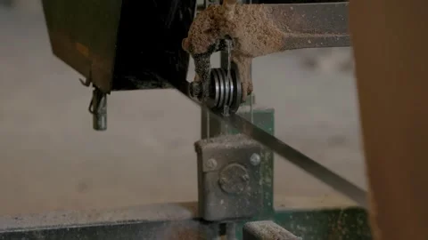 Close-up of dusty bandsaw guide system with vertical blade and metal wheels 스톡 동영상 322683297