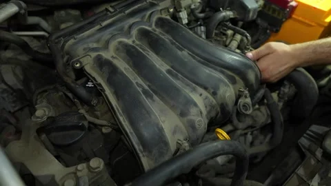 Close-up of a dusty car engine intake manifold being inspected by a mechanic Stock Footage 340334871
