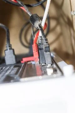 Close-Up of Dusty Network and USB Cables Connected to Computer Back Panel. .. Stock Photos