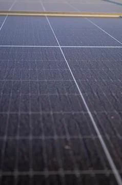 Close-up of a dusty solar panel surface with visible dirt particles and gri.. Stock Photos