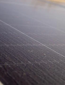 Close-up of a dusty solar panel surface with visible dirt and grid lines, i.. Stock Photos