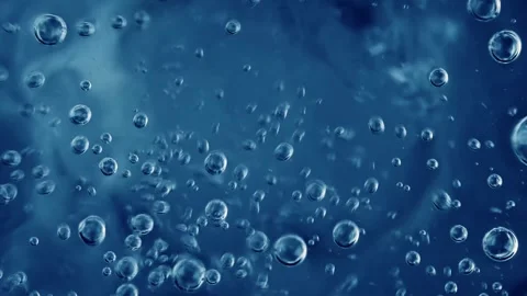 Close-up dynamic motion of clear blue water bubbles rising and swirling in .. Stock Footage 337355813