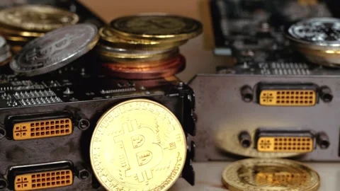 Close up dynamic motion of gold bitcoin coins and computer graphics cards f.. Stock Footage 339203792