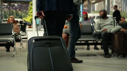 Close up of dynamic travel in bus station with person carrying luggage Stock Footage 334727643