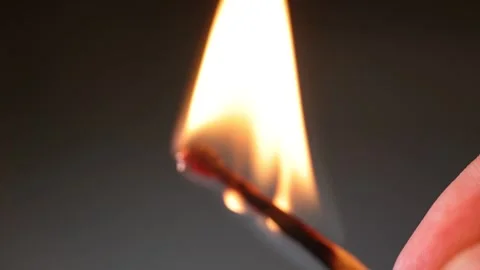 A close-up, dynamic video of a match under the flame Stock Footage 323281552